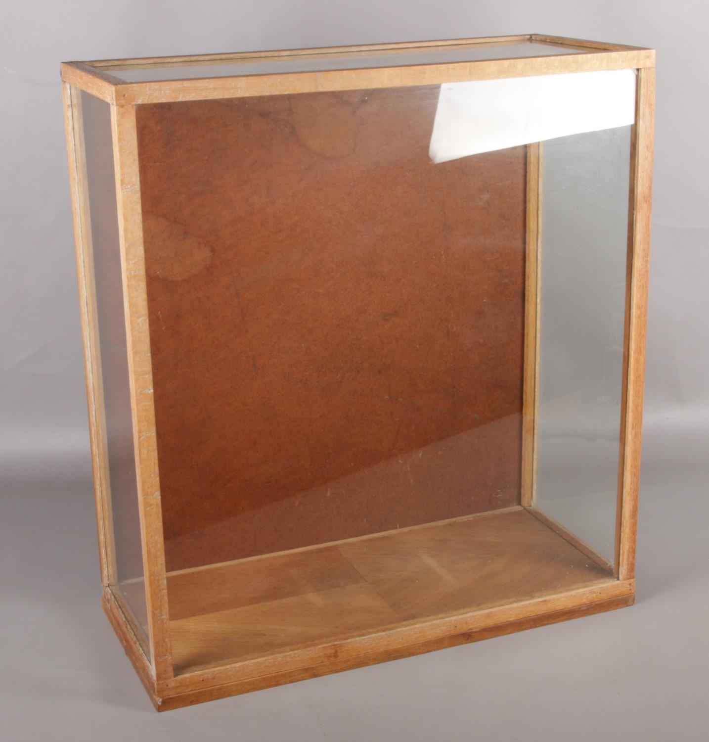 A glass and oak display box. (67cm x 60cm)