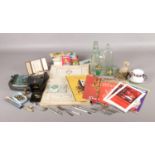 An assortment of collectables. Table cloth and six napkins set, a Harston & Co bottle with glass