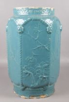 A Chinese hexagonal pottery seat in a blue glaze with prunus blossom decoration. Height 47cm.