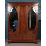 An inlaid mahogany mirror front double wardrobe.