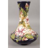 A Moorcroft vase, with narrow neck and flared base in the 'Tea Rose' pattern. Base bears seahorse