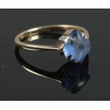 A 9ct gold ring with central blue stone. Size L. Total weight 1.78g.