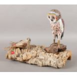 Modern folk art; an owl perched on a piece of bark, together with a hessian covered bird,