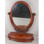 A Victorian carved mahogany dressing table mirror. With storage compartment.