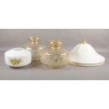 Four light shades. To include a pair of glass pale yellow shades, an opaque shade with floral