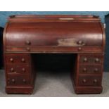 A Victorian mahogany cylinder top bureau set between 2 sets of 3 drawers, with roll top enclosing