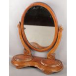 A Victorian carved mahogany dressing table mirror. With two storage compartments.