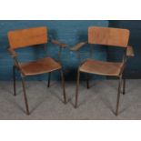 A pair of beech tubular steel frame stacking chairs.