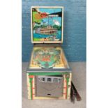 A vintage Bally Delta Queen pinball machine with chrome surround and supports. In need of