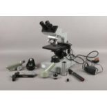 A binocular microscope, by Kyowa Optical (No. 834389), with 3 objectives and microscope accessories.