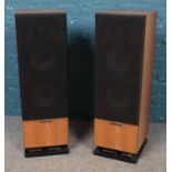 A teak cased pair of Mordaunt-Short speakers. 83cm high. Slight hole to protective speaker cover.