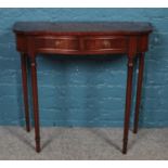 A small mahogany two drawer side table.