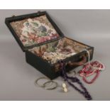 A vintage case with costume jewellery. Beads, bangles etc