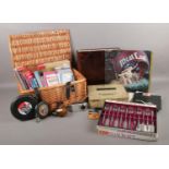 A box and small picnic basket of assorted items. To include a vintage tin first aid kit with