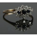 A 9ct gold ring with blue and white paste cluster design. Size P. Total weight: 1.66g. Stamped 375.