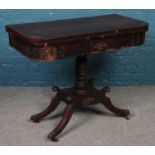 A Regency mahogany folding card table with baize insert and brass inlay decoration. Set on turned