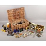 A wicker basket containing an extremely large assortment of collectables. To include letter openers,