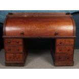 A Victorian oak cylinder bureau, with knee hole between 2 pedestals of 3 drawers. Roll top enclosing