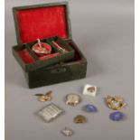 A vintage jewellery box to include locket pendants badges etc