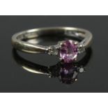 A 9ct white gold and diamond ring with pink stone centre piece. Size J 1/2. Total weight 1.32g.