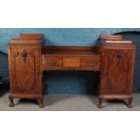 A Regency carved mahogany twin pedestal sideboard on ball and claw feet. Height 116cm Width 198cm