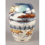 A Moorcroft vase, in the 'Woodside Farm' pattern, depicting a winter landscape and foxes, stamped