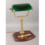 A vintage desk lamp, with green shade and pen tray.
