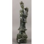 A carved spinach Jade oriental figure. 25.5cm height. damage to head been glued