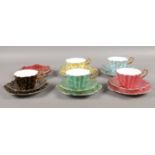 A collection of five Royal Stuart trios. (to include a red saucer & plate)