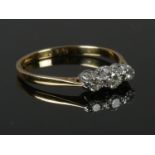 A vintage 18ct gold three stone diamond ring, size T. 2.74g.