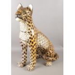 A large ceramic leopard, 60cm high. Stamped to the base 1643 (indistinct).