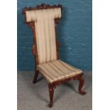 A carved mahogany prayer dieu chair.