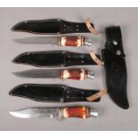 Three Original Bowie Knives. With horn handles and leather sheaths, along with a spare leather