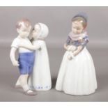 A Royal Copenhagen porcelain figure of a girl, along with a Bing & Grondahl figure group of a boy