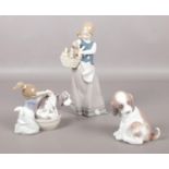 Three Lladro figurines. 'Puppies in a basket' No. 1311, 'Gentle surprise' No. 6210, 'Bashful bather'