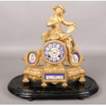 A French gilt metal mantel clock surmounted with an artist painting a portrait and having Sevres