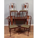 A Queen Anne style burr walnut dining table and set of four matching chairs.