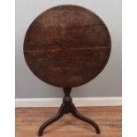 A George III tilting circular table on tripod base. (68.5cm height 70 cm width)