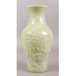 A Chinese Peking glass celadon coloured baluster vase decorated in relief with prunus blossom, 26cm.