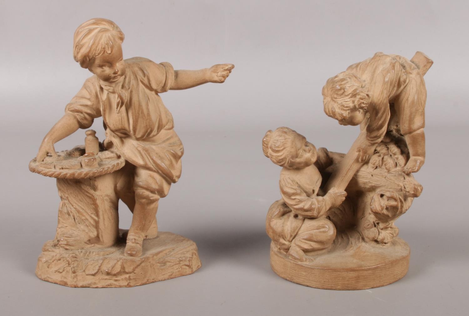 A pair of late 19th century French small terracotta sculptures. One of a young boy posing as a