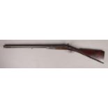 A Charles Pryse & Co double barrelled combination rifle. With damascus barrels and walnut stock.