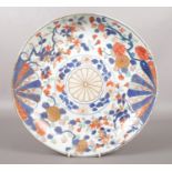 A 19th century Chinese Imari dish. Painted with a brocade pattern incorporating mons and trailing