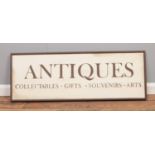 A Parlane 'Antiques' wooden sign. 38cm height 108cm width.