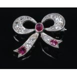 An Art Deco ruby and diamond brooch in the form of a bow. 2cm x 2.2cm. 3.37g. Jewellers repair to