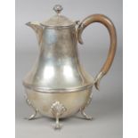 A George V silver hot water pot raised on four scrolled supports. Assayed Birmingham 1919 by