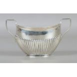 A twin handled silver sugar bowl, assayed for Birmingham, 1909, by Charles Boyton & Son Ltd. Total