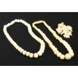 Two Ivory bead necklaces and a decoratively carved bone crucifix. Necklaces: L:16cm. Crucifix : L: