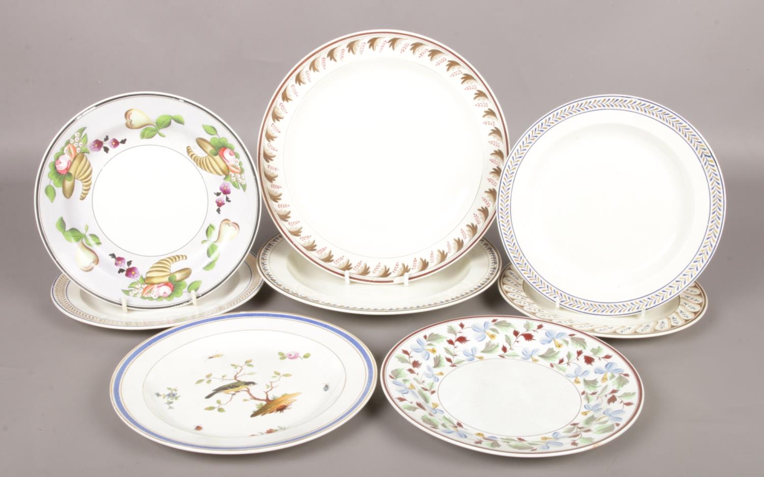 Eight early 19th century Wedgwood creamware plates. Includes example painted with a bird perched