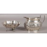 Two pieces of silver; a small milk jug with embossed decoration, assayed for Birmingham, 1908, by