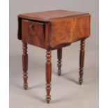 A Regency walnut work table raised on turned and reeded supports.